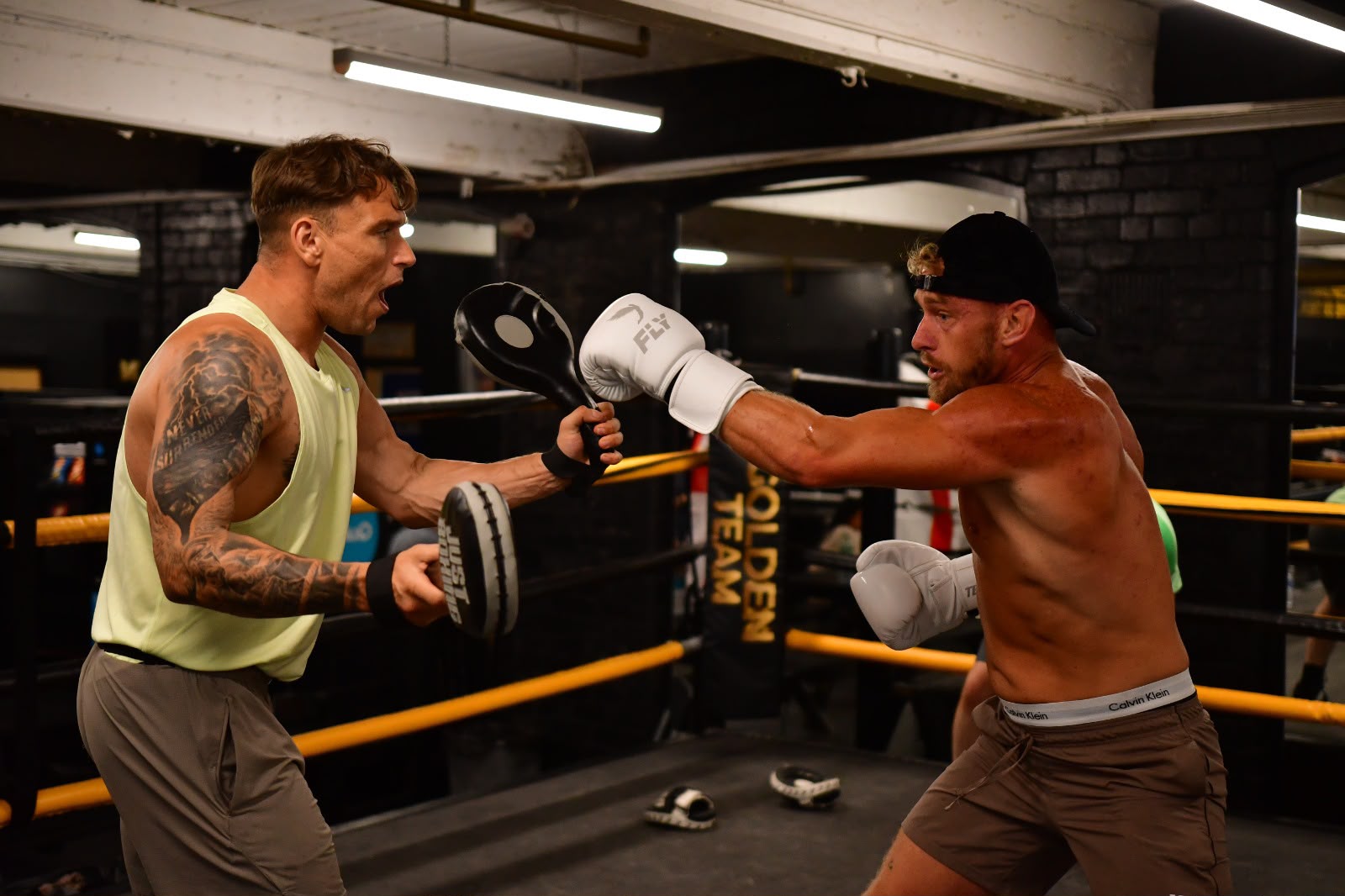 Coach holding pads during a sparring drill