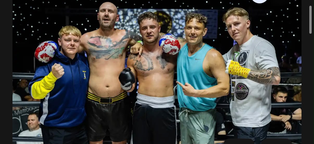 Team celebration in the ring after a fight